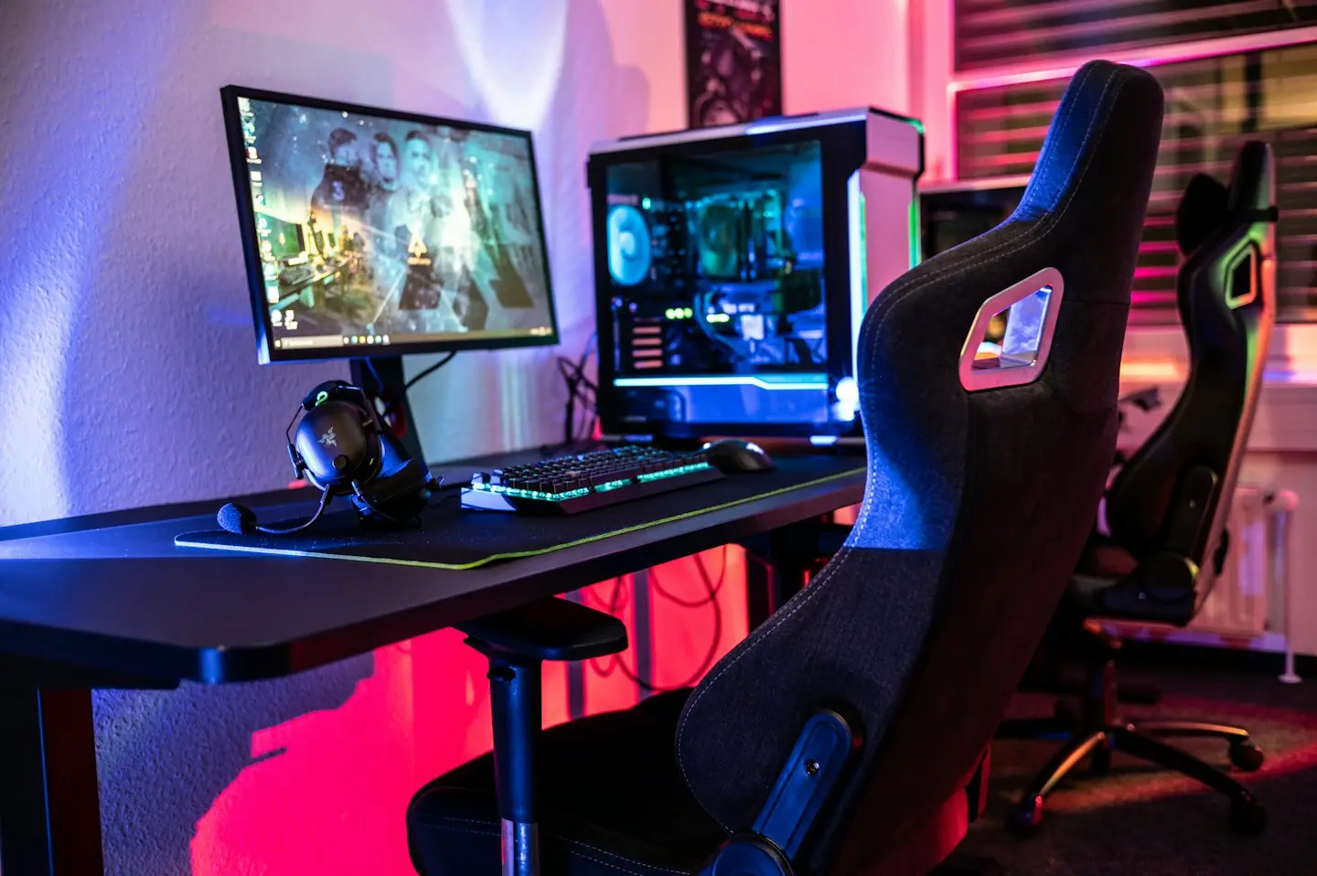 Gaming setup with RGB PC, keyboard, mouse, and headset.